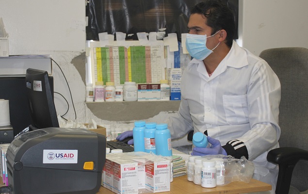 Namibia Pharmacist Alexey Ramos dispensing MMD bottles of TLD