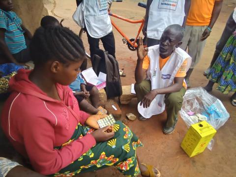 CHW Kasakula Godfrey explaining to community patient Chomba Karen about how to take her malaria treatment medication in Felushi Village under Kandeke zone of Kefulwa RHC catchment. Photo Credit: GHSC-PSM