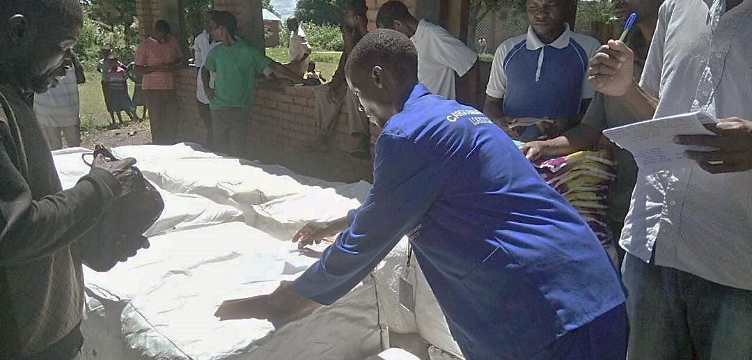 Ministry of Health officials and community members prepare for distribution of LLINs at one of three displaced persons camps. Photo credit: GHSC-PSM