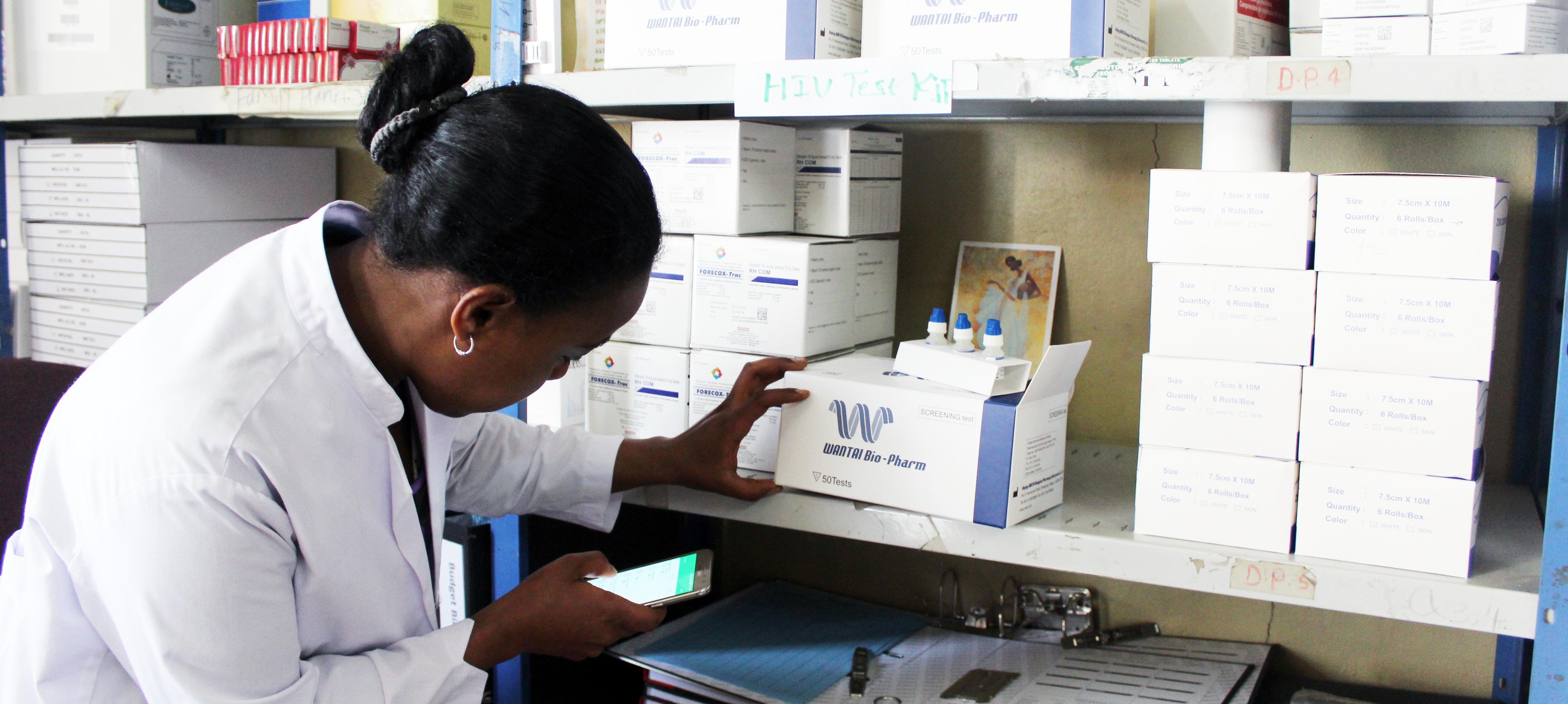 A woman checks stock levels at a pharmacy