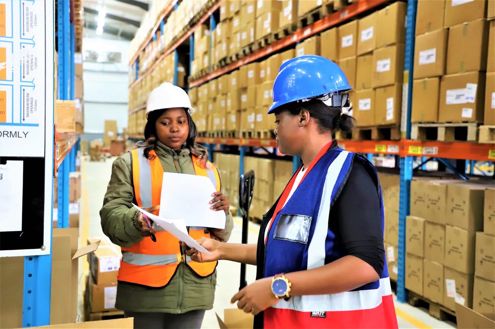 Two women in a warehouse