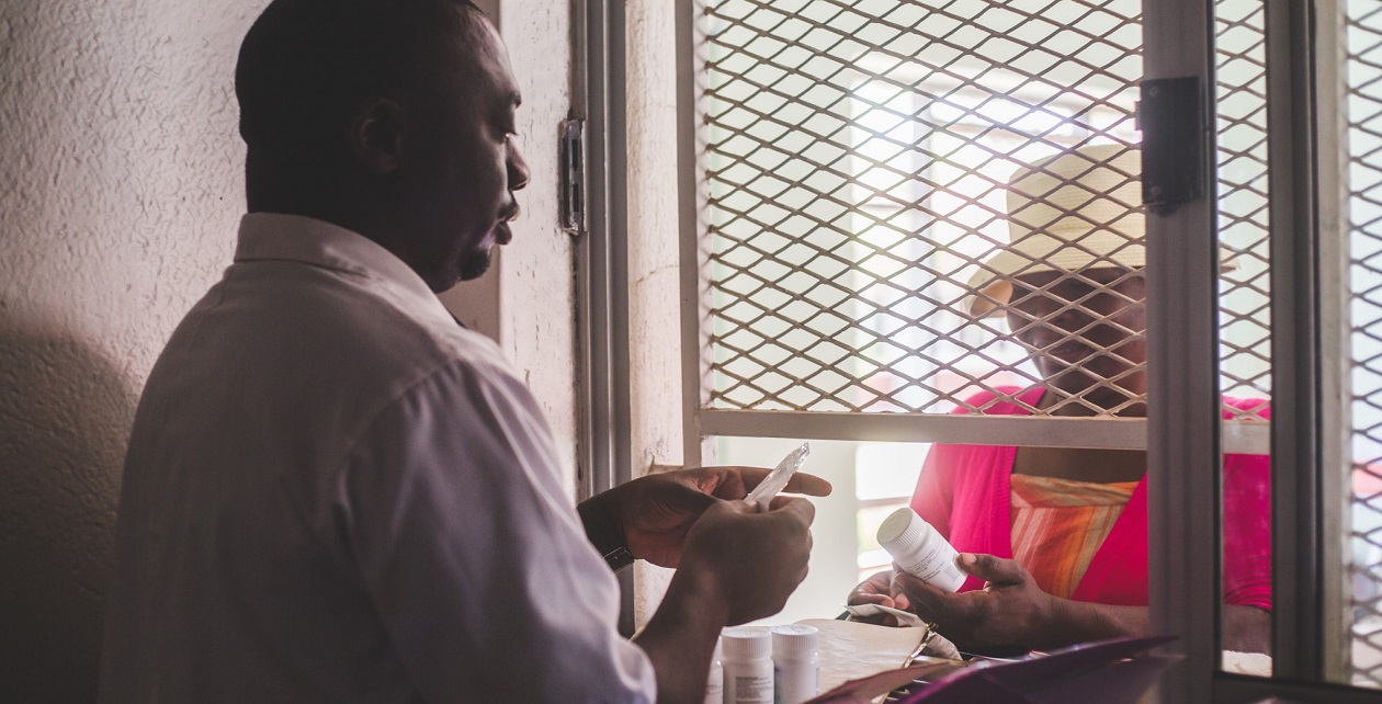 Patient collecting medicine from a pharmacy in Zimbabwe