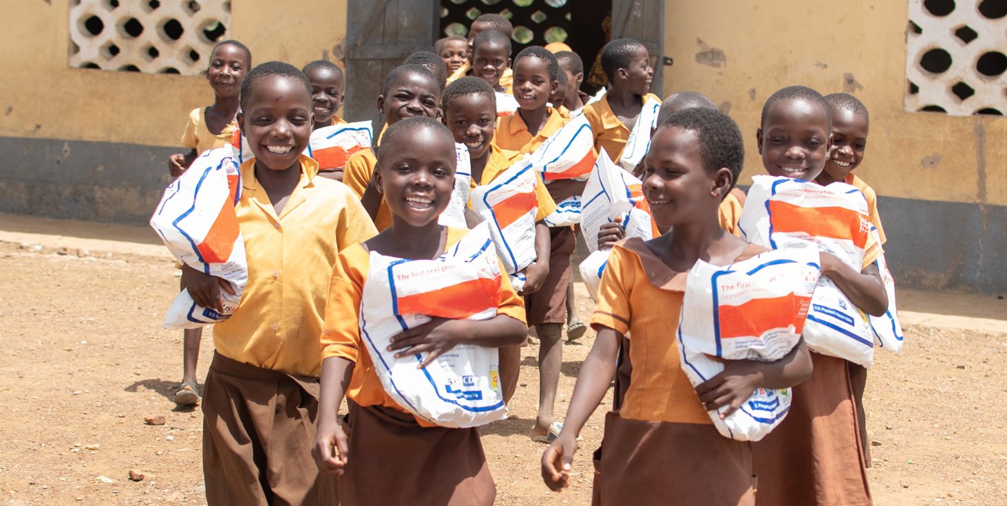 Students in Ghana holding LLIN