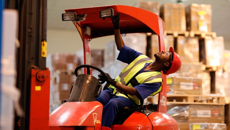 A warehouse worker in Mozambique is trained on operating a forklift