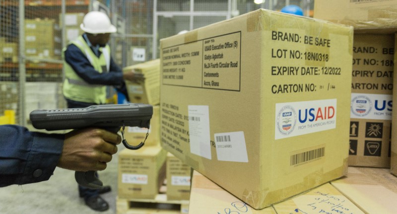 Man scans boxes in warehouse