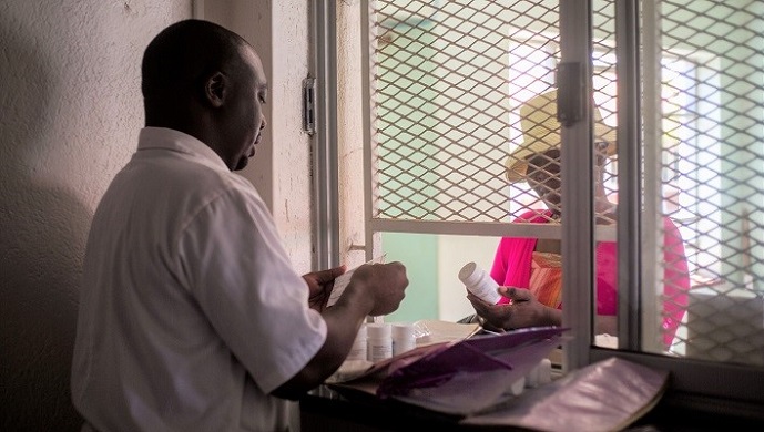 Pharmacist dispensing medicine to a patient in Zimbabwe