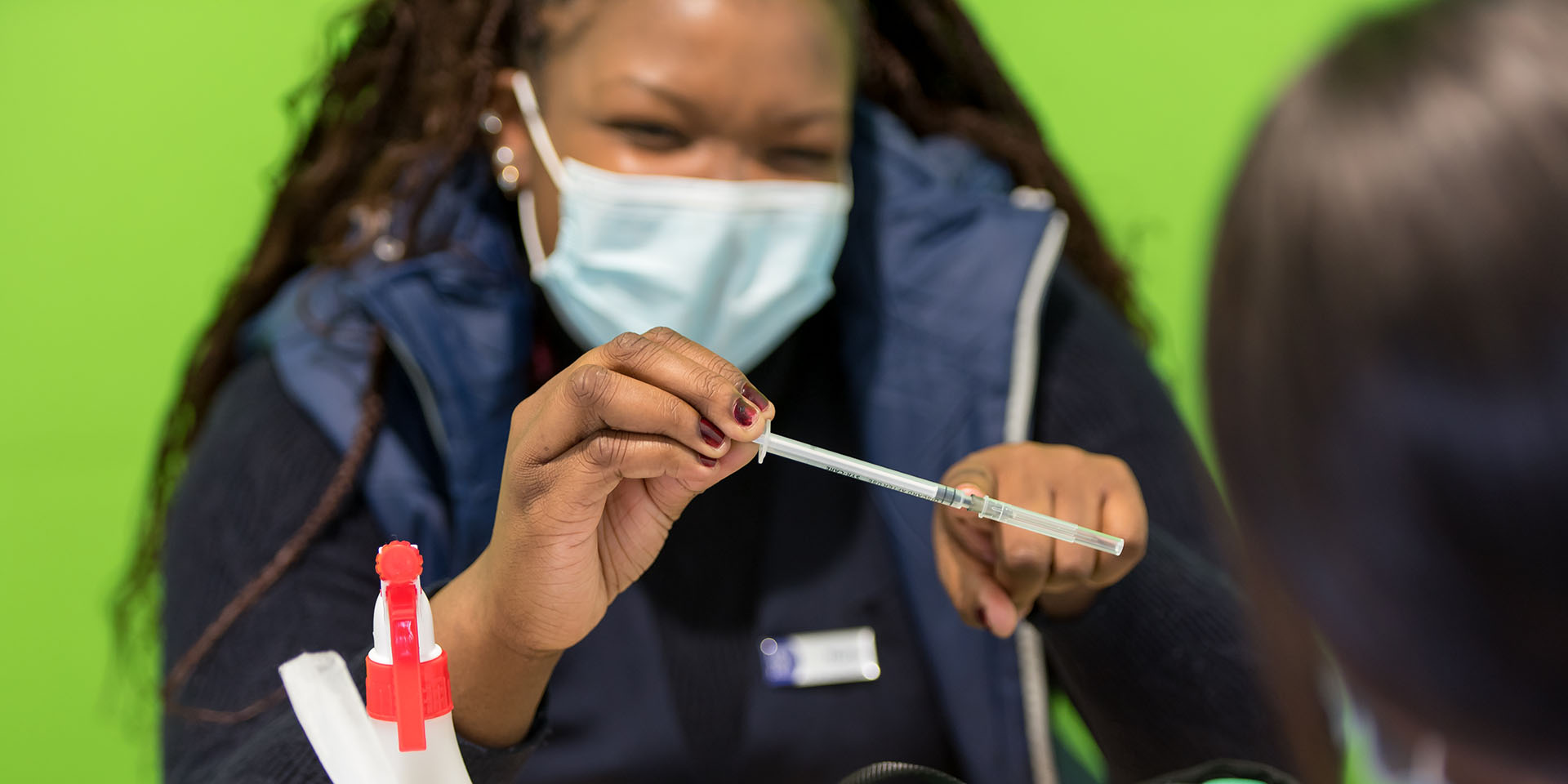 A nurse attending to a patient at the SA Taxi Vaccination Site.