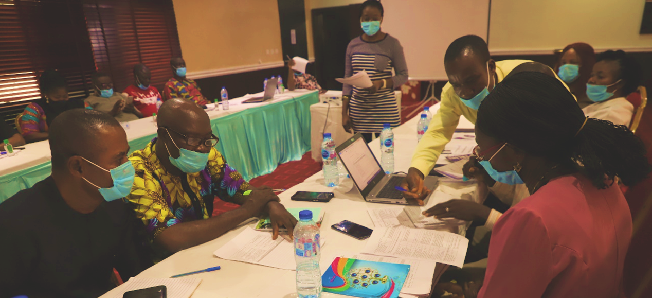 community representatives review and discuss documents at a conference table in Ebonyi State, Nigeria