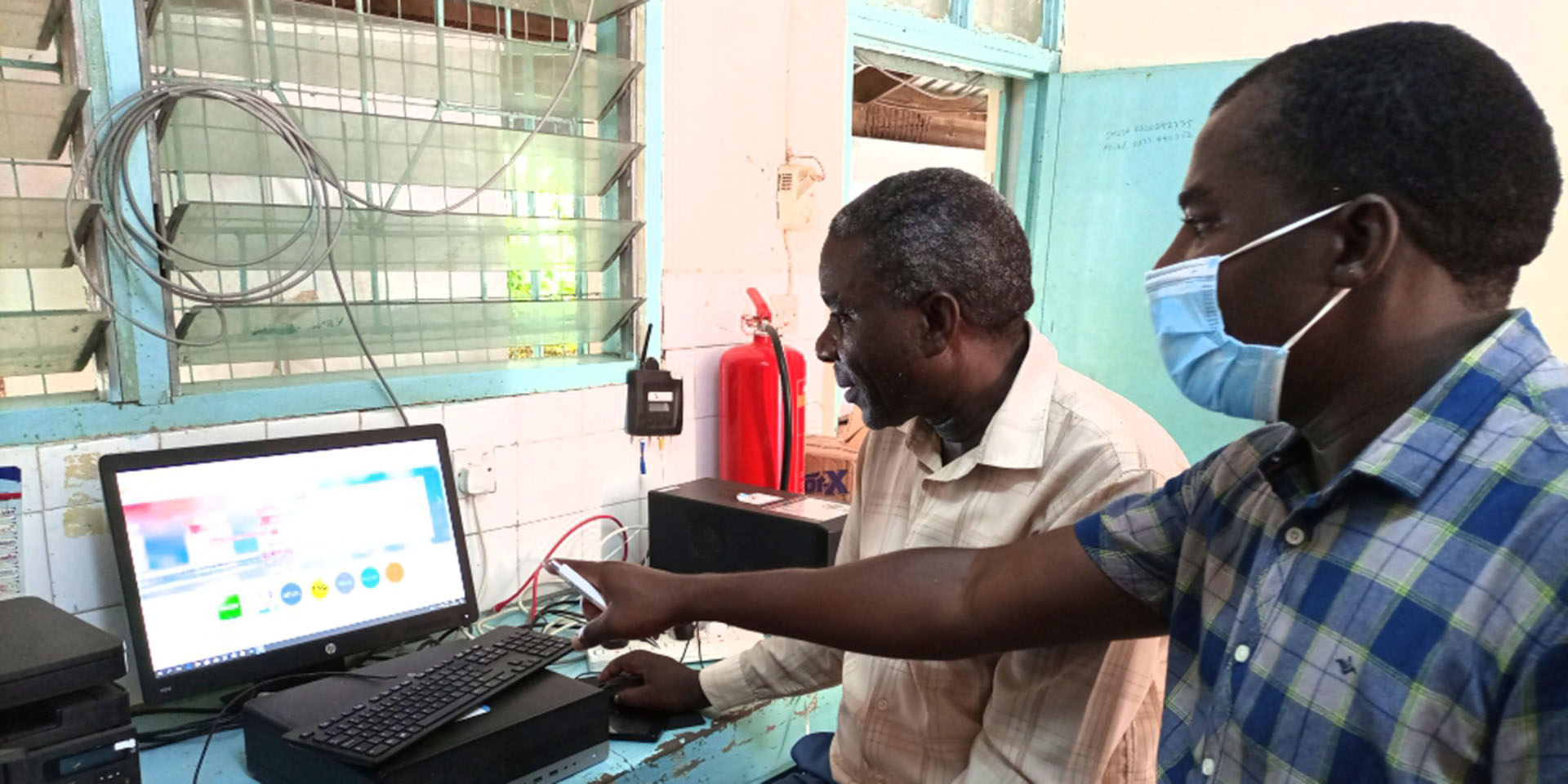 Elias Onyango of USAID MTaPS teaching Samuel Omuga of Garissa country referral hospital how to create an account on PVERS portal, February 2022