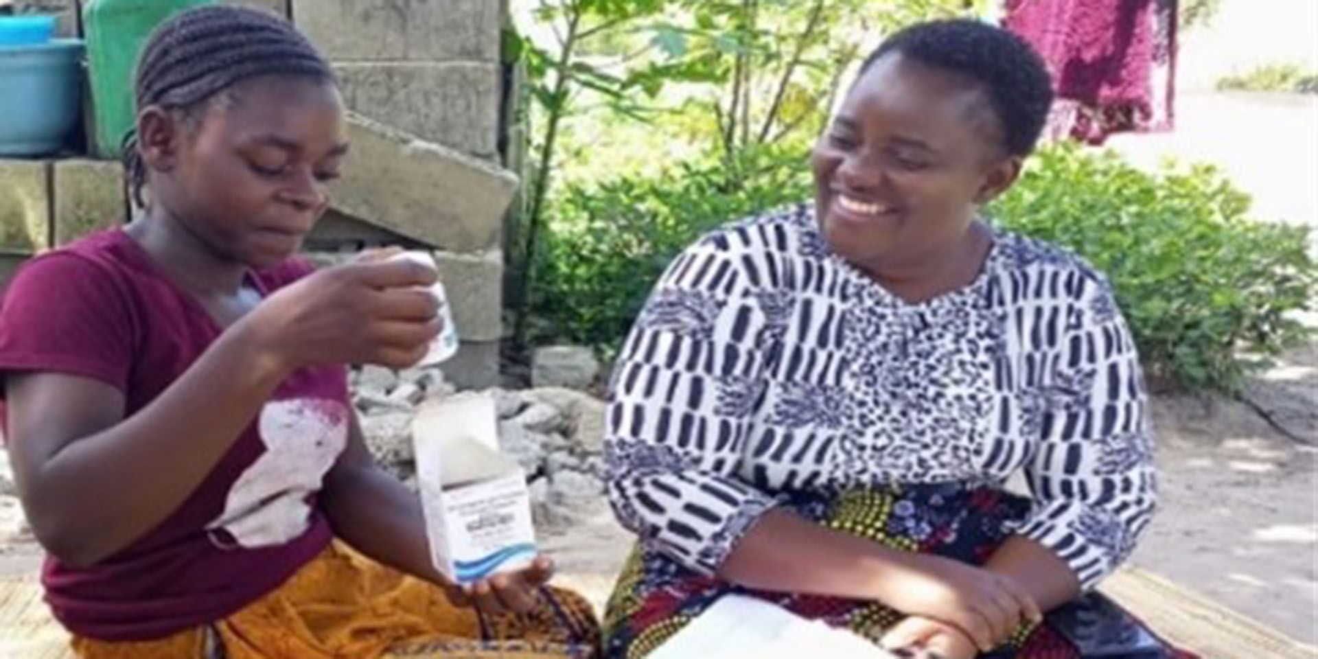 Deborah Chimuka speaks with Site Coordinator Priscilla Makasa during the community PrEP refill discussion which promotes medication adherence. 