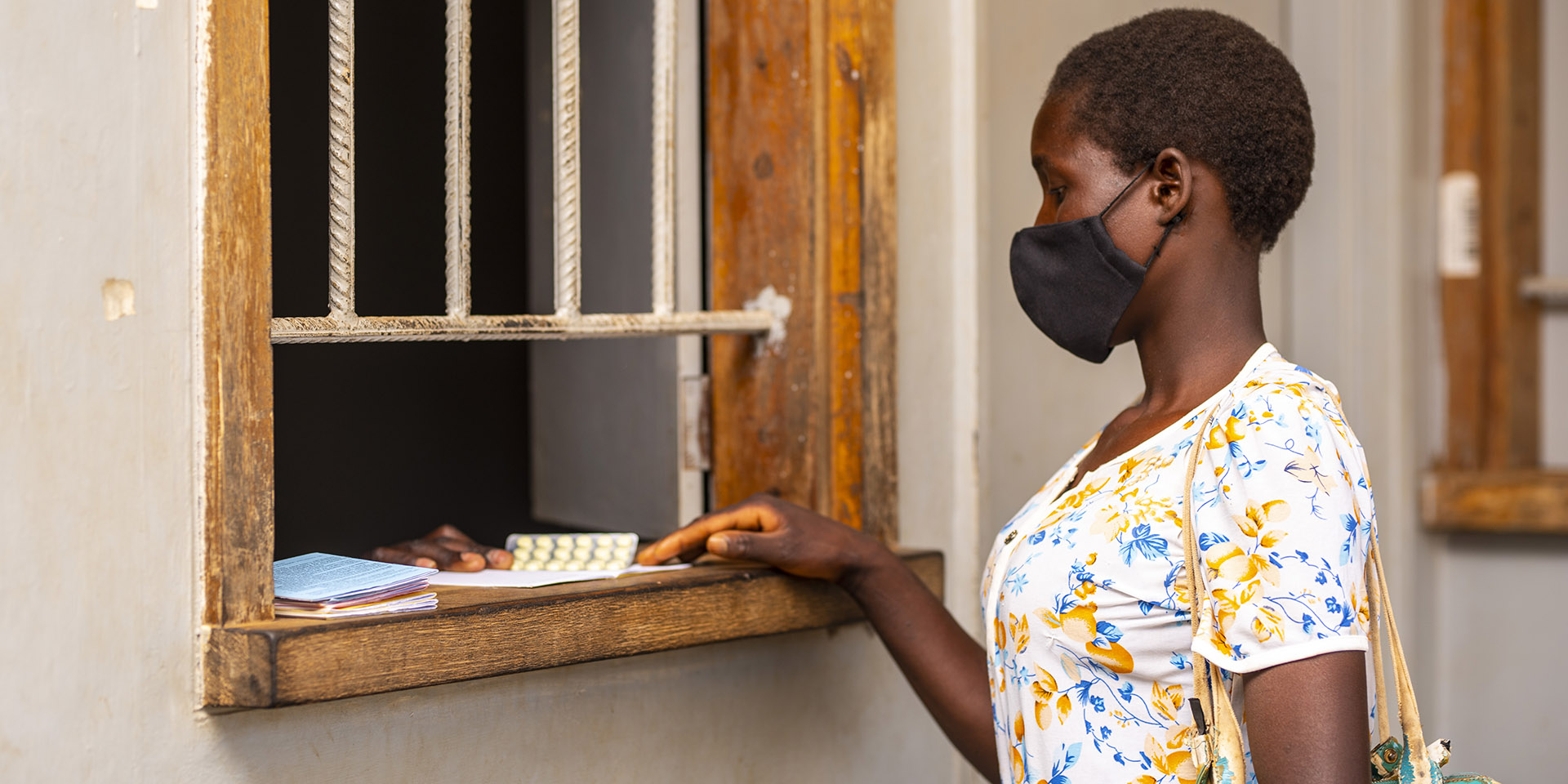 A patient receiving medicine from a pharmacist at Nthondo Health Centre in Ntchisi district. Photo by GHSC-PSM