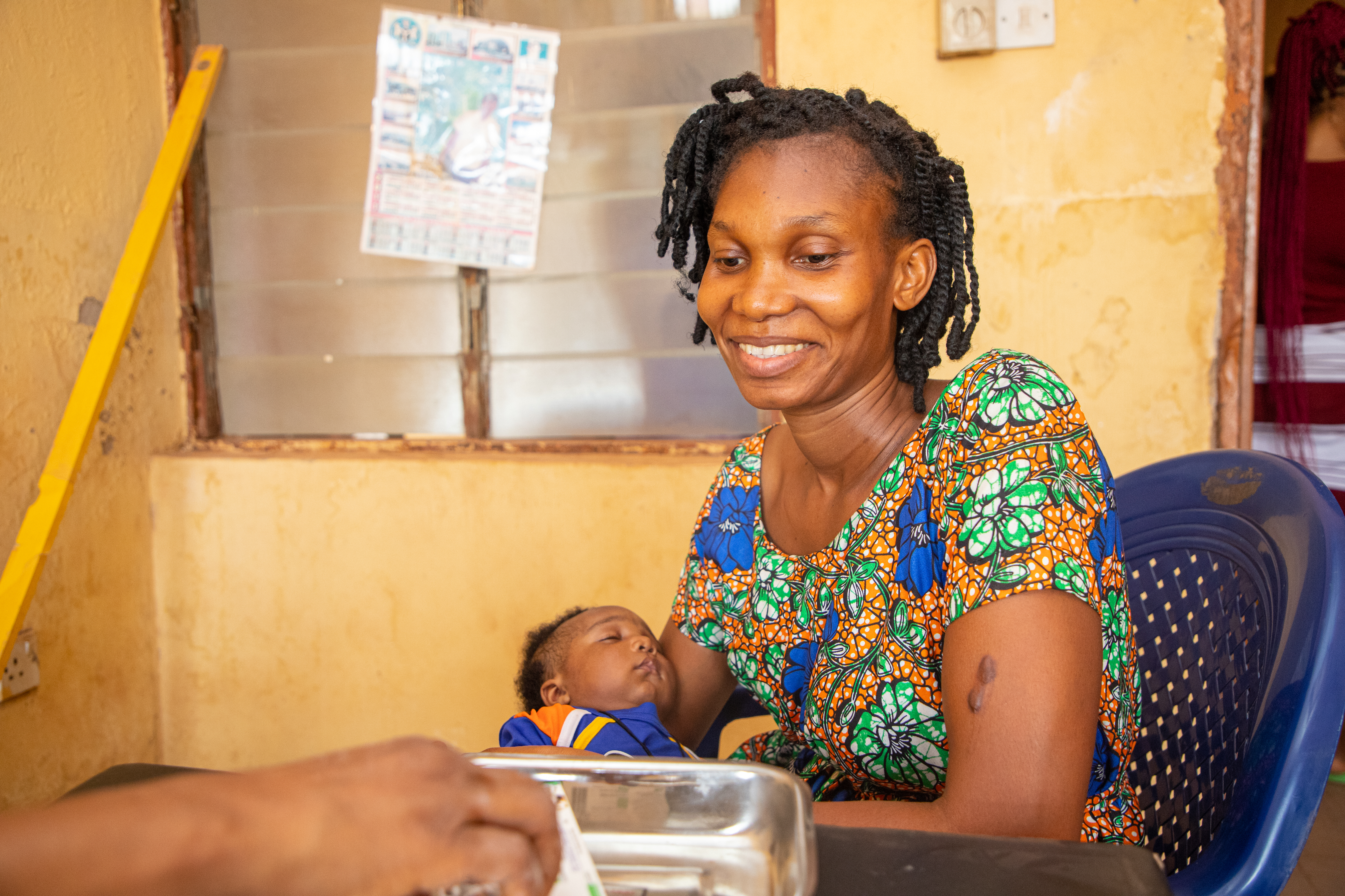 Mrs Blessing Nniekwe, mother of a two months old child talking to a health officer on her experience using chlorhexidine on her child at Nkwegu Model PHC in Ebonyi state 