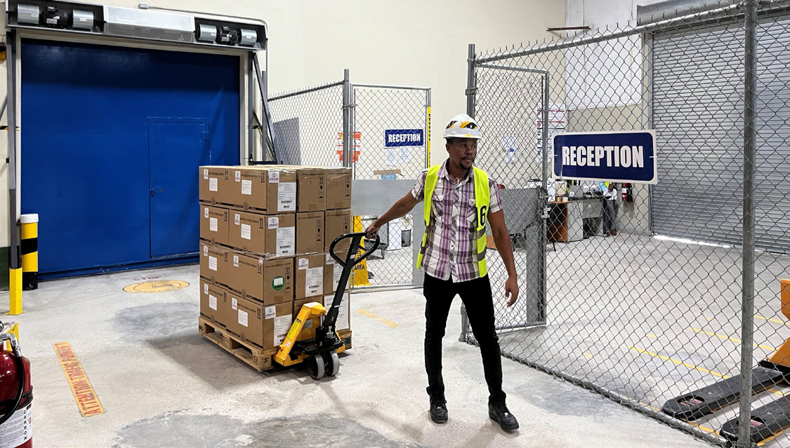 Warehouse Operative, Pierre Wilson, completing transfer between ambient and temperature-controlled spaces