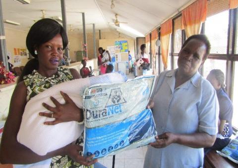 Image of a new mother receiving an LLIN at Juba Teaching Hospital after her first postnatal visit. 
