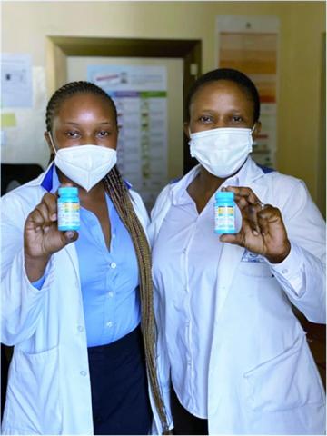 Martha Sakala and Soneni Chelemu, Pharmacists at University Teaching Hospital in Lusaka, Zambia showing bottles of DTG 10mg.