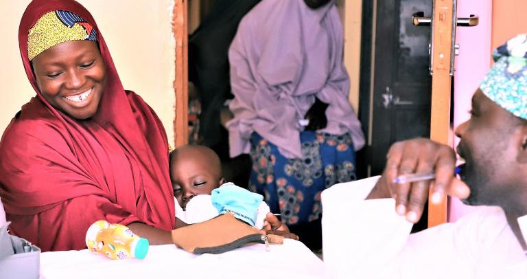 A woman is told that free anti-malaria drugs are available at a hospital in Nigeria